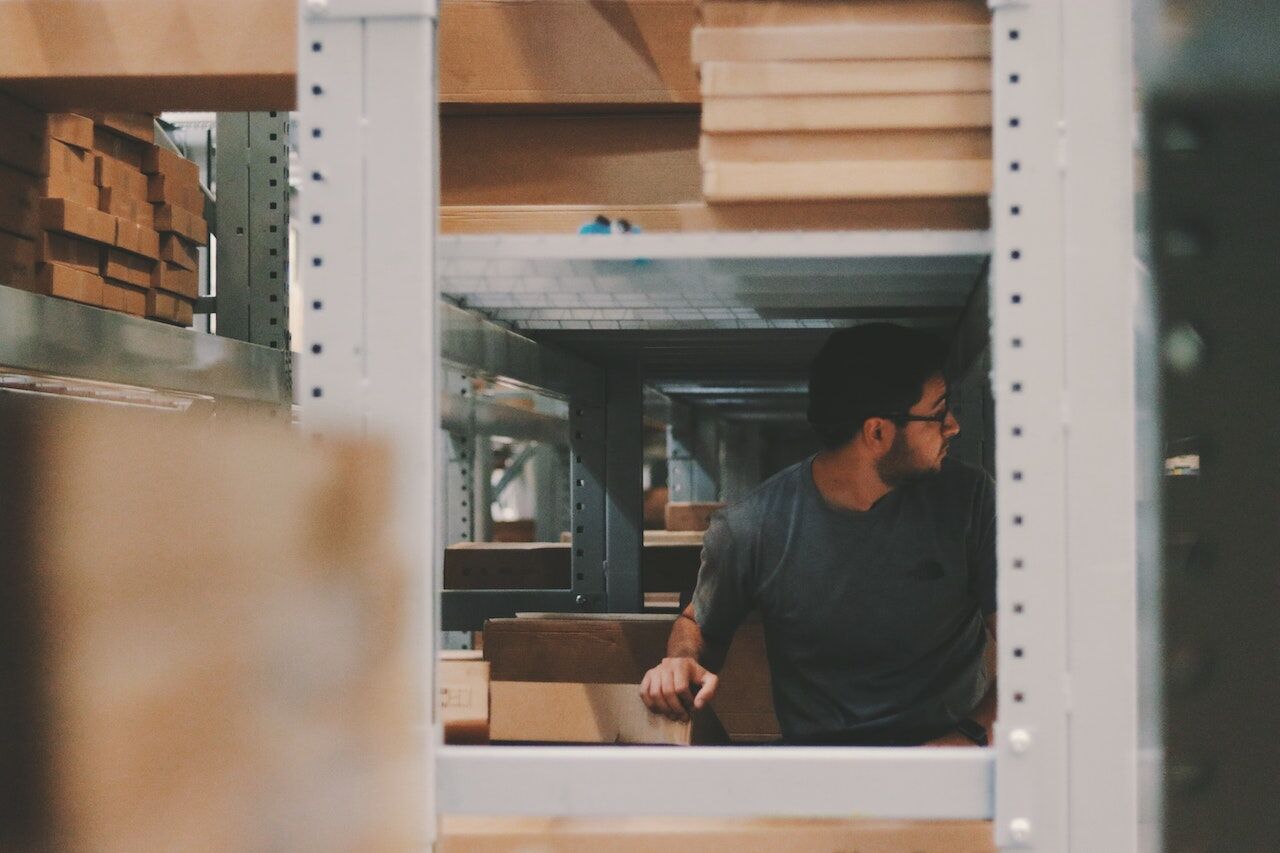 Man considers optimal storage solutions in his storage area